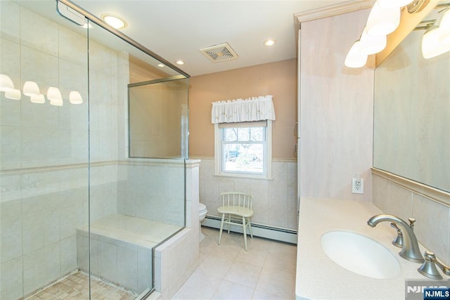 full bathroom featuring a stall shower, visible vents, a baseboard heating unit, and tile walls