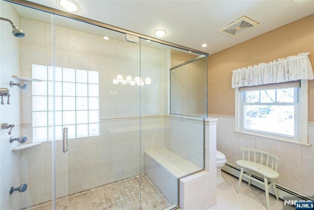 bathroom featuring visible vents, toilet, a baseboard radiator, tile patterned floors, and a shower stall