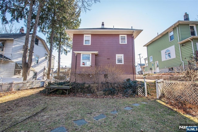 back of house with fence