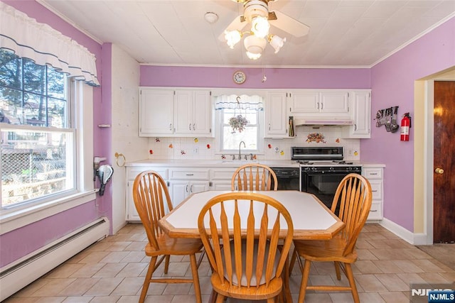 kitchen with under cabinet range hood, a baseboard heating unit, white cabinets, light countertops, and gas stove