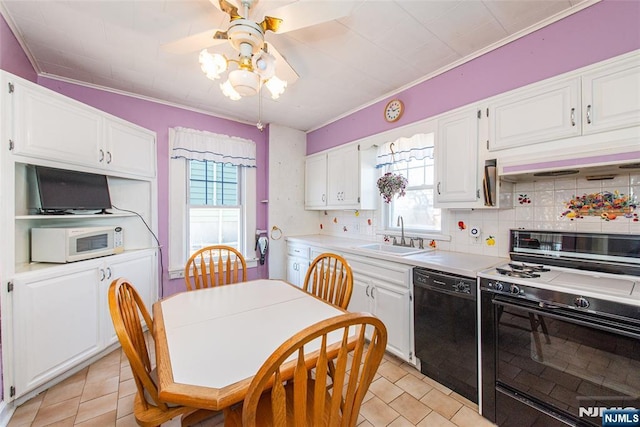 kitchen with white microwave, white cabinets, a sink, gas range, and dishwasher