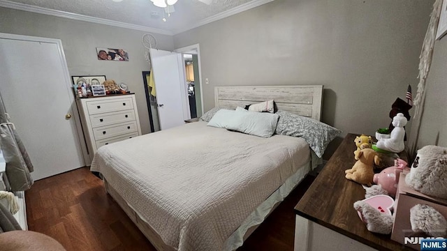 bedroom with ceiling fan, crown molding, and wood finished floors