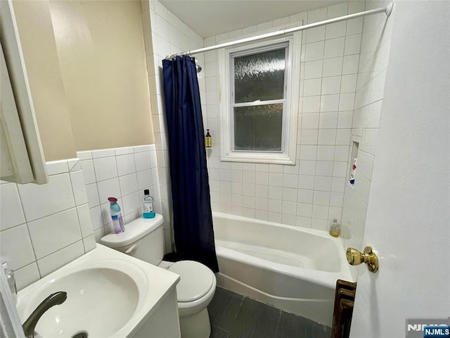 full bathroom featuring toilet, wood finished floors, vanity, tile walls, and shower / bathtub combination with curtain