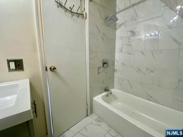 full bath with marble finish floor, shower / washtub combination, and vanity