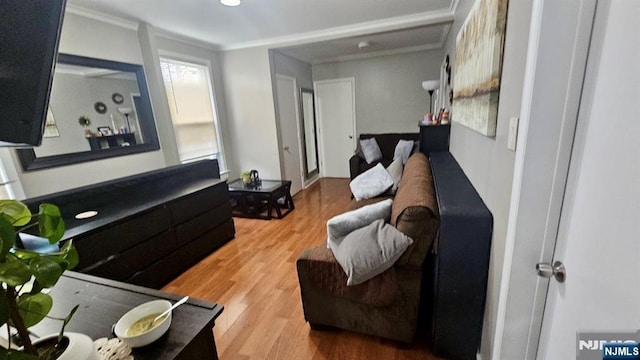 living room featuring ornamental molding and wood finished floors