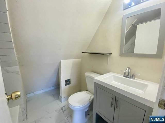 full bathroom featuring marble finish floor, vanity, toilet, and baseboards