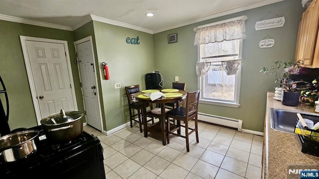 dining area featuring ornamental molding, baseboards, baseboard heating, and light tile patterned floors