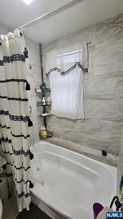 full bath featuring shower / bath combo