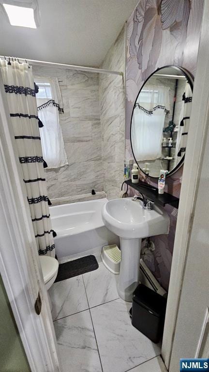 bathroom with marble finish floor, toilet, and shower / tub combo with curtain