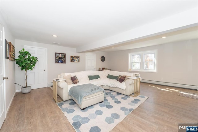 living room featuring light wood-style flooring, a baseboard heating unit, baseboards, and recessed lighting