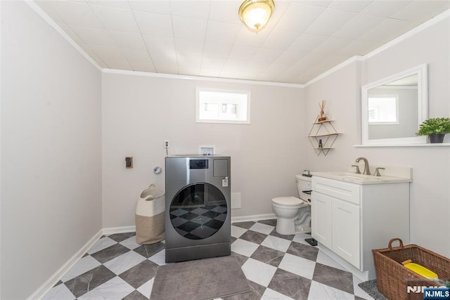 bathroom with ornamental molding, washer / clothes dryer, baseboards, and tile patterned floors