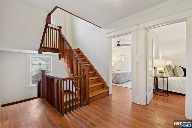 stairs featuring ornamental molding, hardwood / wood-style flooring, and baseboards