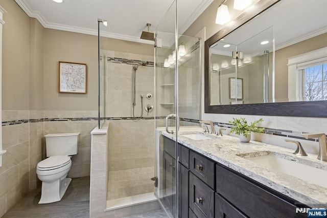 bathroom with a stall shower and a sink