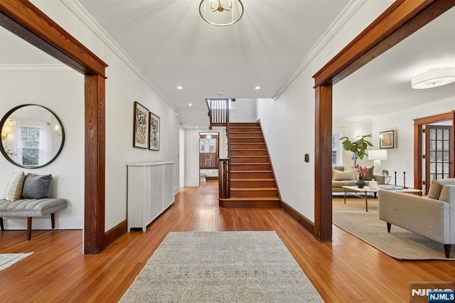 entrance foyer with crown molding, recessed lighting, wood finished floors, baseboards, and stairs