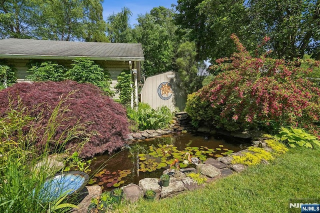 details featuring a small pond and a downspout