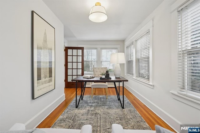 office area featuring wood finished floors and baseboards