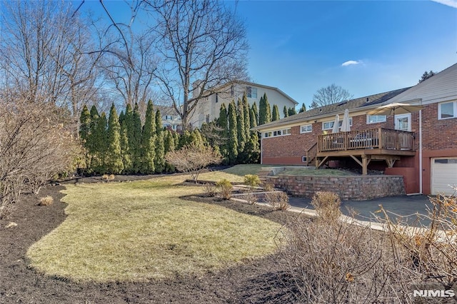 view of yard featuring a garage and a deck