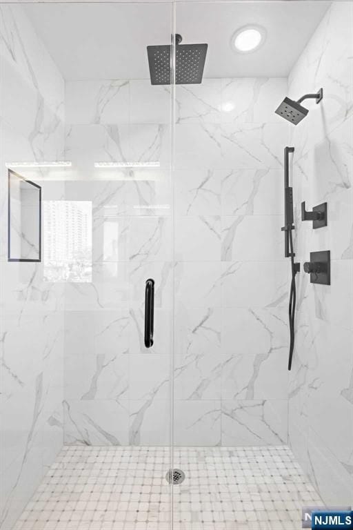 bathroom with a marble finish shower