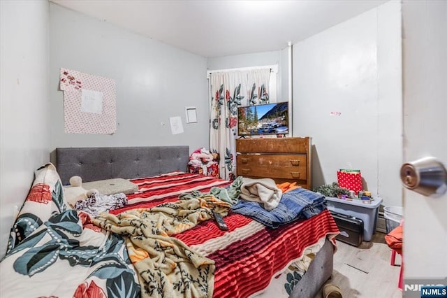 bedroom with wood finished floors