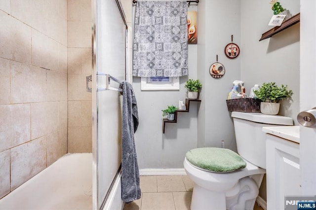 bathroom featuring tile patterned flooring, toilet, and baseboards