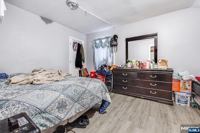 bedroom with a closet and wood finished floors