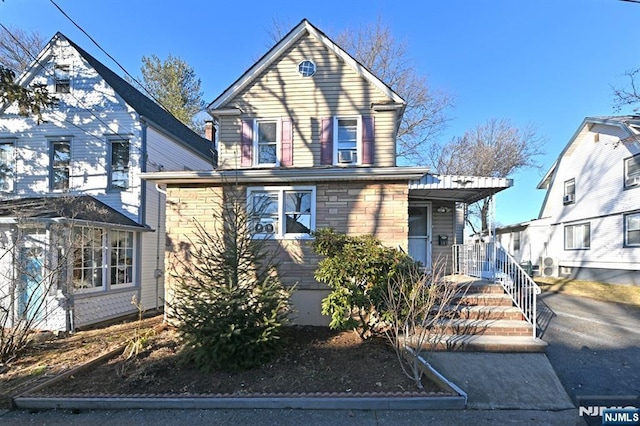 traditional-style house featuring stone siding