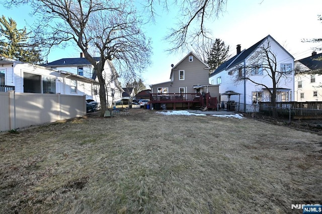 view of yard with a deck and fence