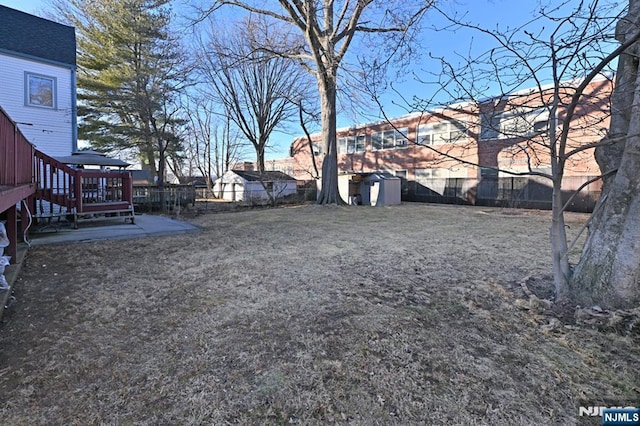 view of yard with a fenced backyard, a shed, and an outdoor structure