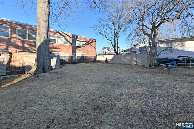 view of yard with a fenced backyard