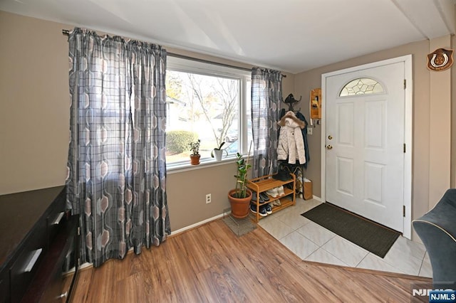 entrance foyer featuring baseboards and wood finished floors