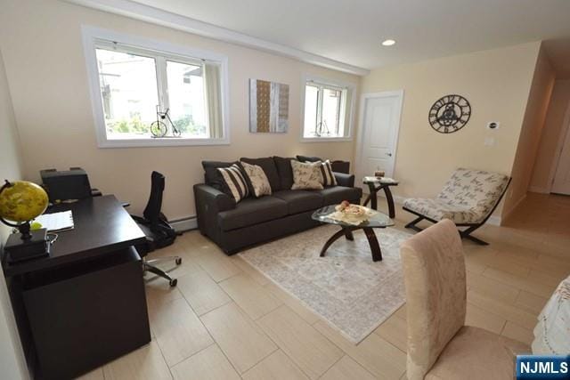 living room with baseboard heating and recessed lighting