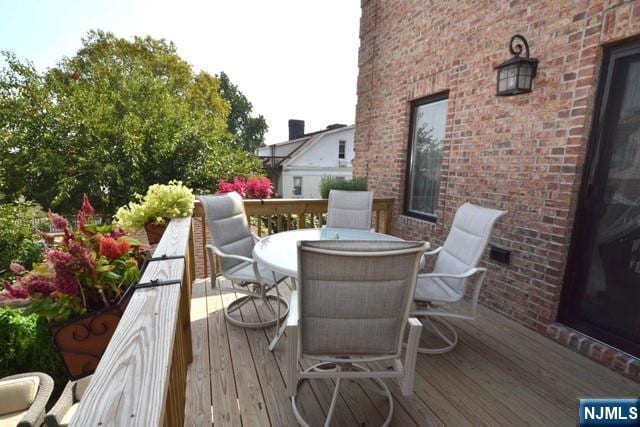 wooden deck with outdoor dining space