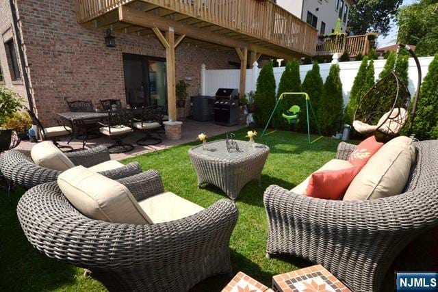 view of patio / terrace with outdoor lounge area, fence, and grilling area