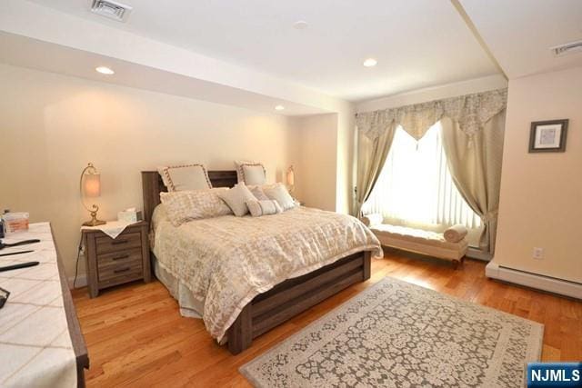 bedroom with recessed lighting, visible vents, and light wood-style flooring