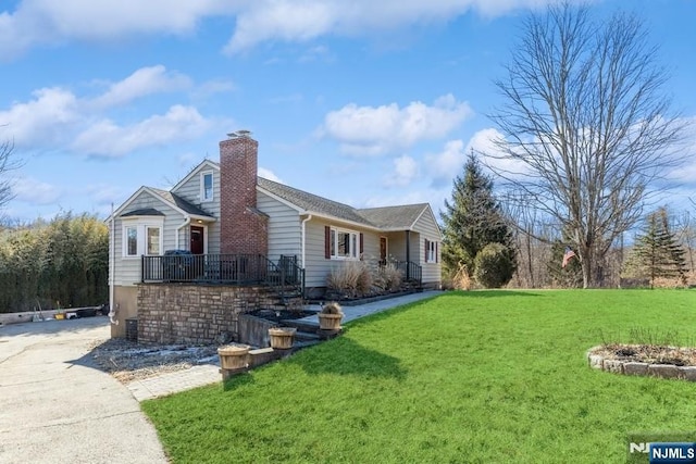 view of property exterior featuring a lawn and a chimney