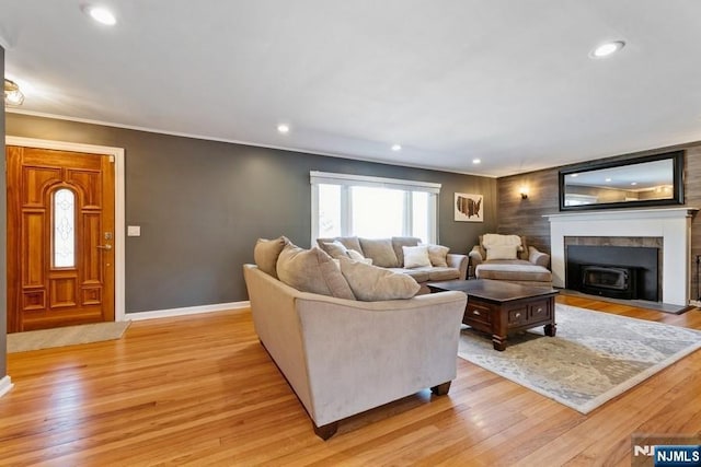 living room featuring recessed lighting, baseboards, and light wood finished floors