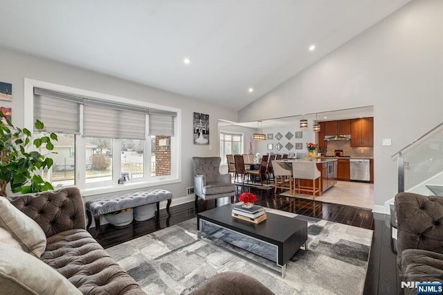 living room with baseboards, stairs, recessed lighting, light wood-style floors, and high vaulted ceiling