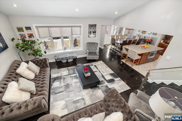 living area with recessed lighting, baseboards, and wood finished floors