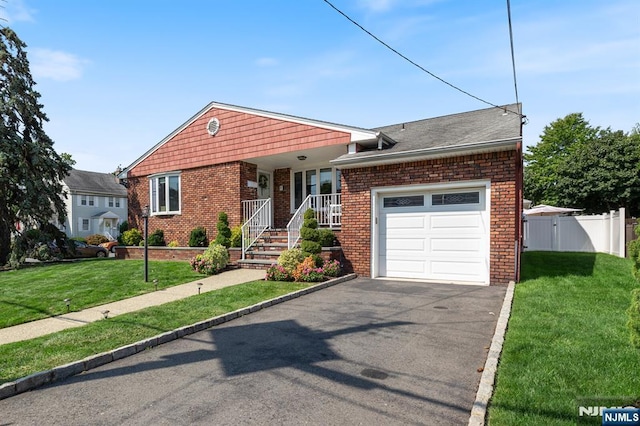 ranch-style home featuring a front lawn, an attached garage, covered porch, and brick siding