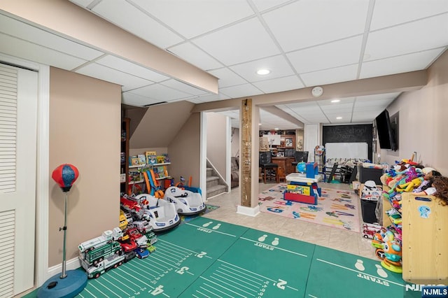 rec room with tile patterned flooring, recessed lighting, and a paneled ceiling