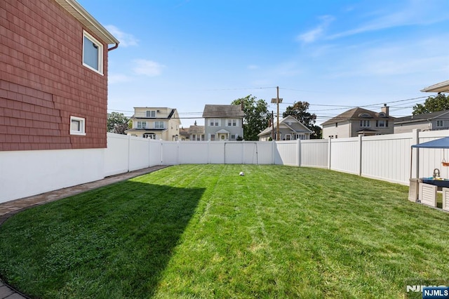 view of yard with a fenced backyard