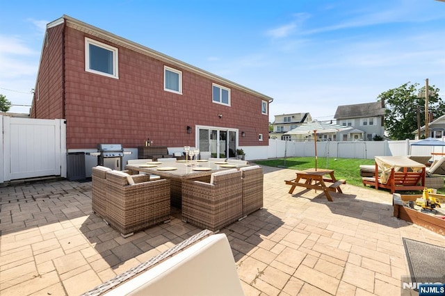 view of patio featuring outdoor dining space, a grill, and a fenced backyard