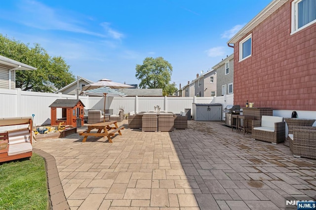 view of patio / terrace with area for grilling, a fenced backyard, and outdoor lounge area