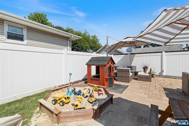 view of patio / terrace featuring a vegetable garden, a fenced backyard, and an outdoor hangout area