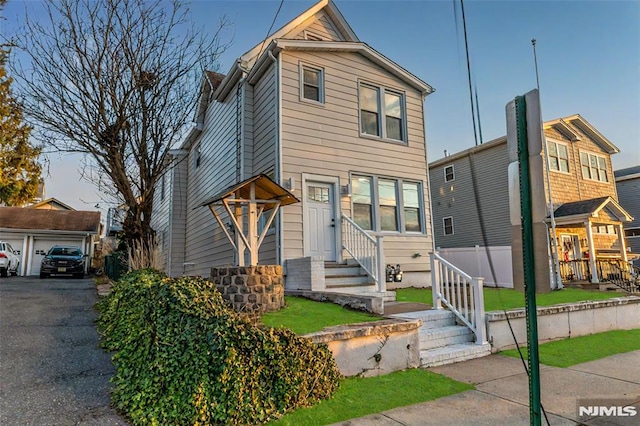 view of front of house with entry steps and an outdoor structure