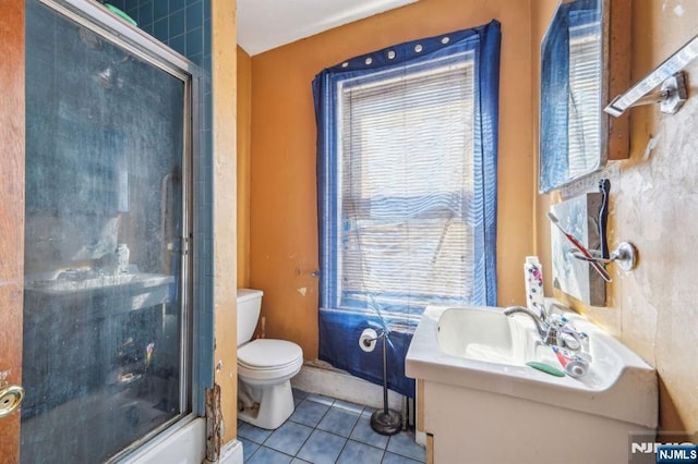 full bathroom with tile patterned floors, an enclosed shower, toilet, and vanity