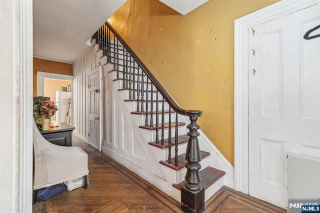 staircase featuring wood finished floors