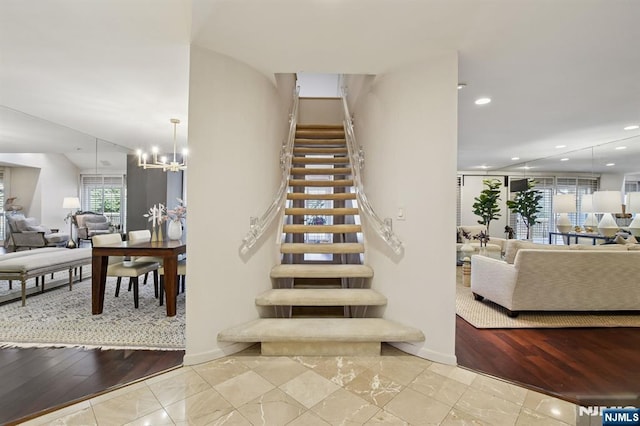 staircase featuring recessed lighting and a notable chandelier