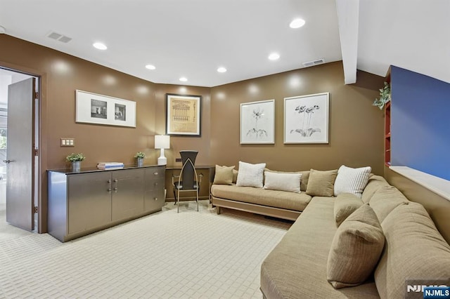 carpeted living area with visible vents and recessed lighting