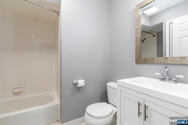 full bathroom with baseboards, toilet, shower / washtub combination, and vanity